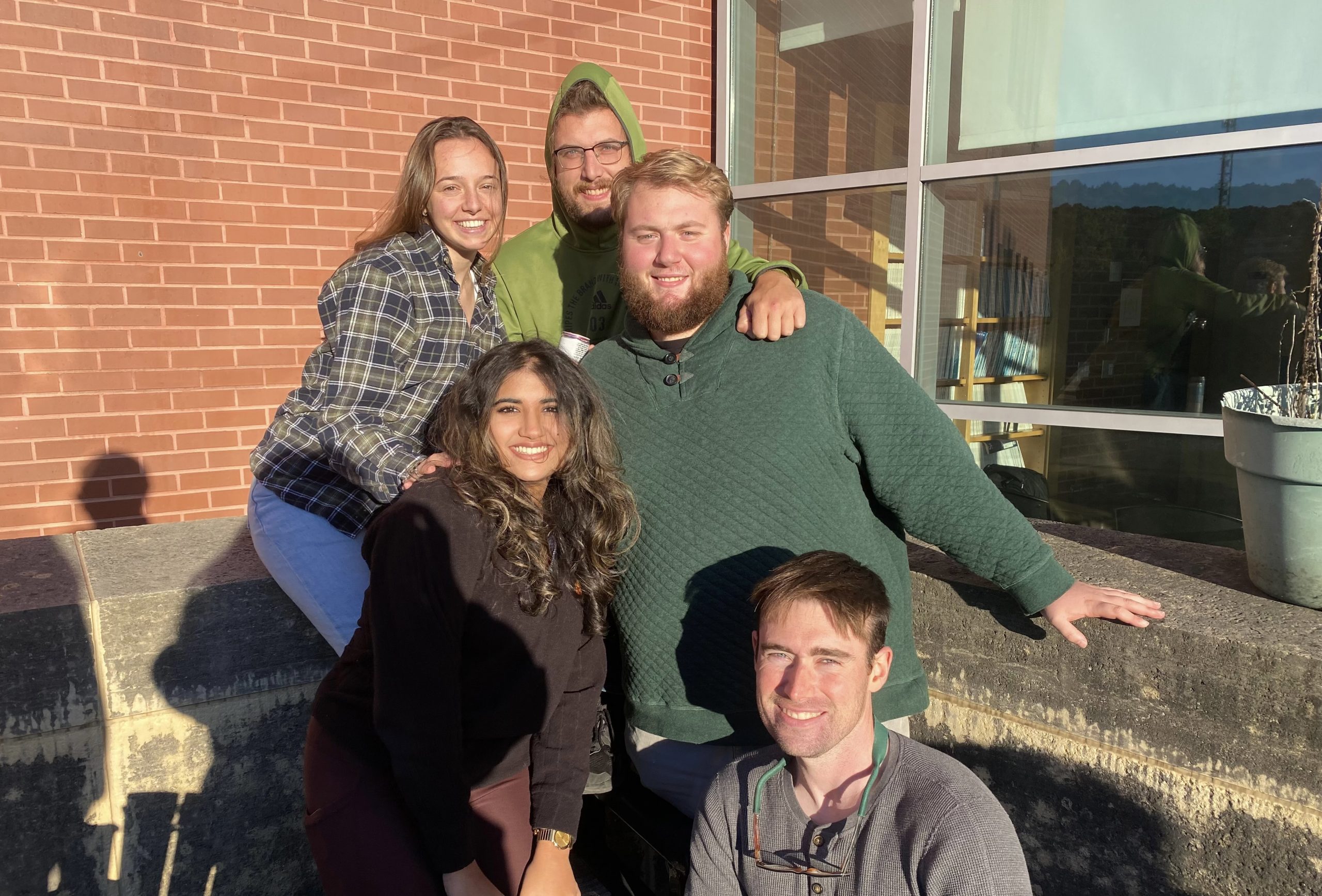 Members of the Goldhamer Lab socializing on a cool Spring day outside of the Biology-Physics Building